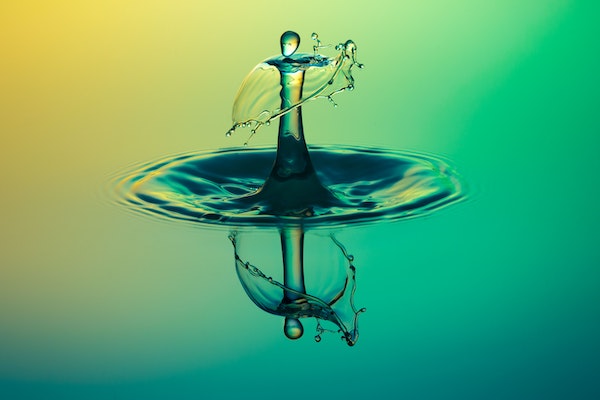 close up image of water drop splashing into shape of person