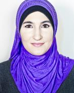 Portrait of Linda Sarsour wearing a purple headscarf