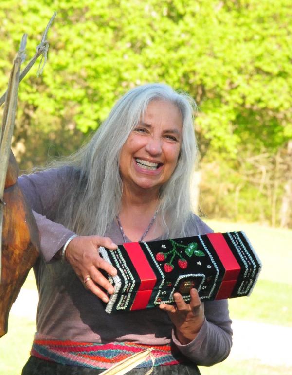 Karen Ann Hoffman smiling and holding raised beadwork box