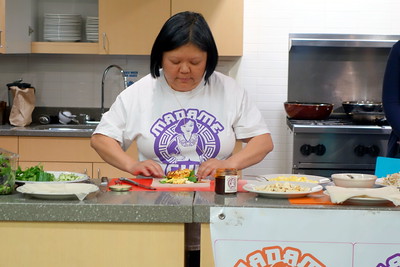 Image of Madame Chu rolling a spring roll