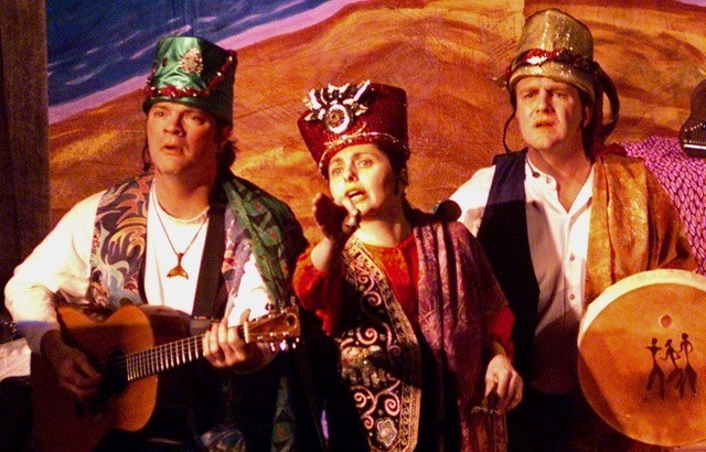 image of three actors in costume looking into distance
