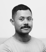 Mike Curato, author of Flamer black and white headshot of Mike Curato, a filipino man with a thick mustache, wearing a light colored t-shirt and smiling softly